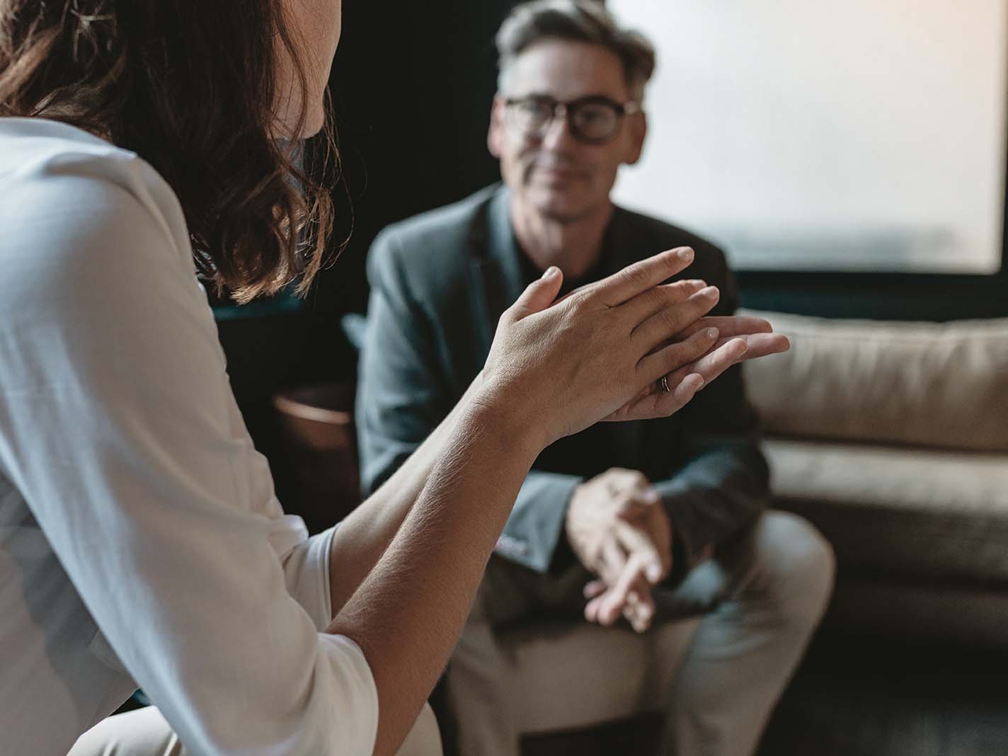 Two employees in flexible office workspace having meeting