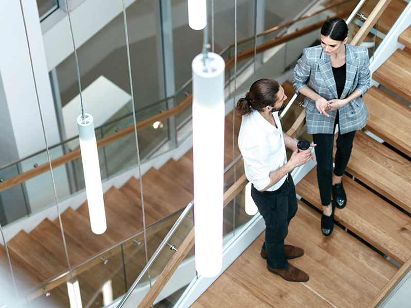 Coworkers meeting on internal staircase