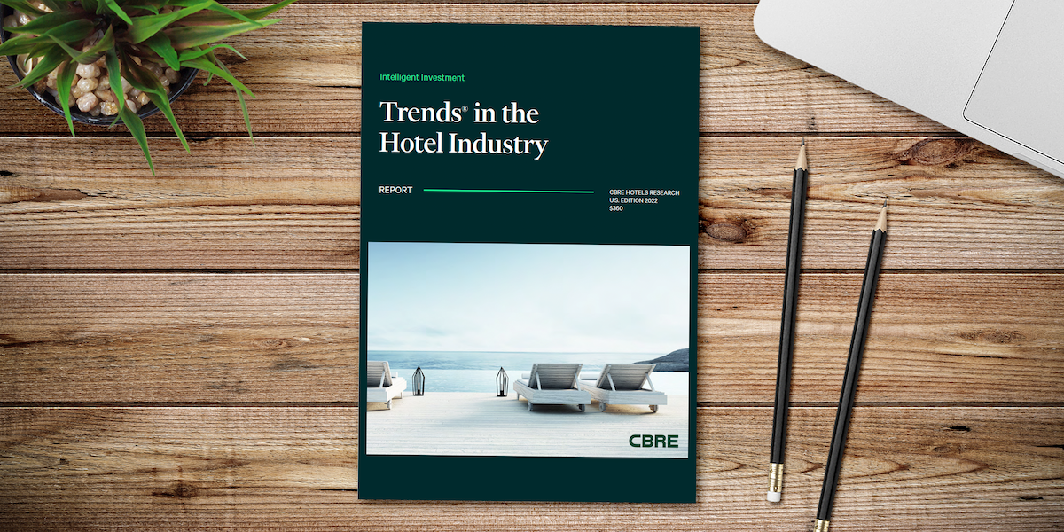cbre hotel trends in the hotel industry report on a desk